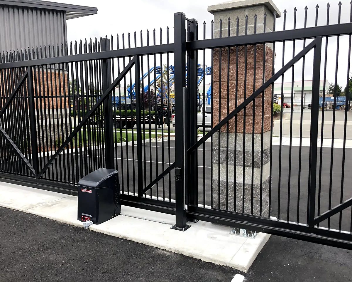 Black metal sliding gate with its gate operator at a commercial entrance