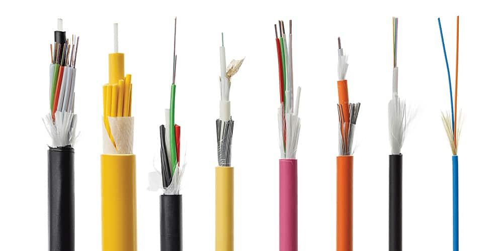 Several fiber optic cables with their outer jackets stripped to show the fibers