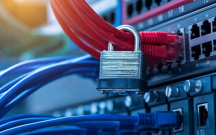 Network switch with red and blue patch cables secured by a padlock